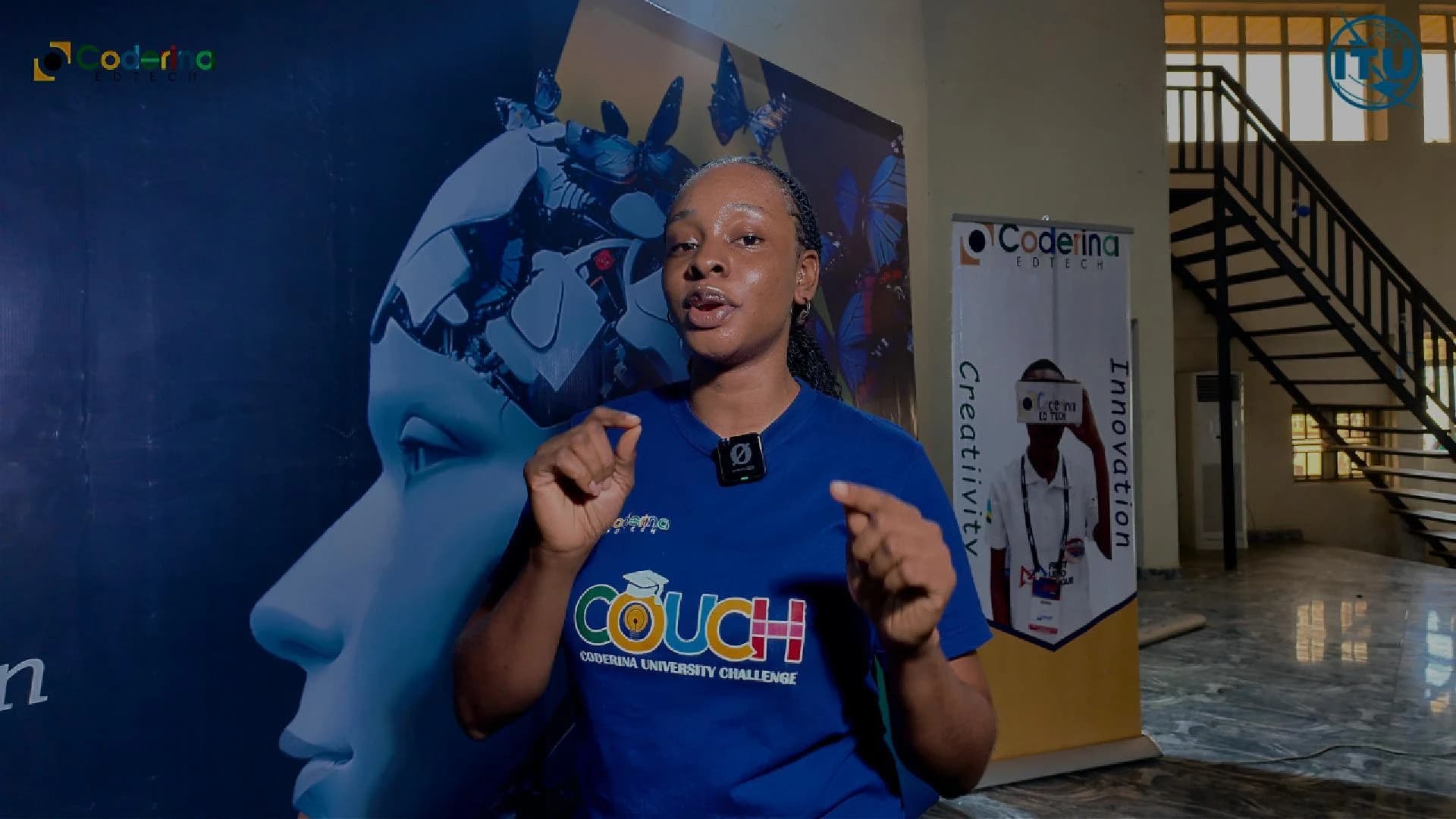 Peace in a COUCH shirt speaking to camera at a Coderina event