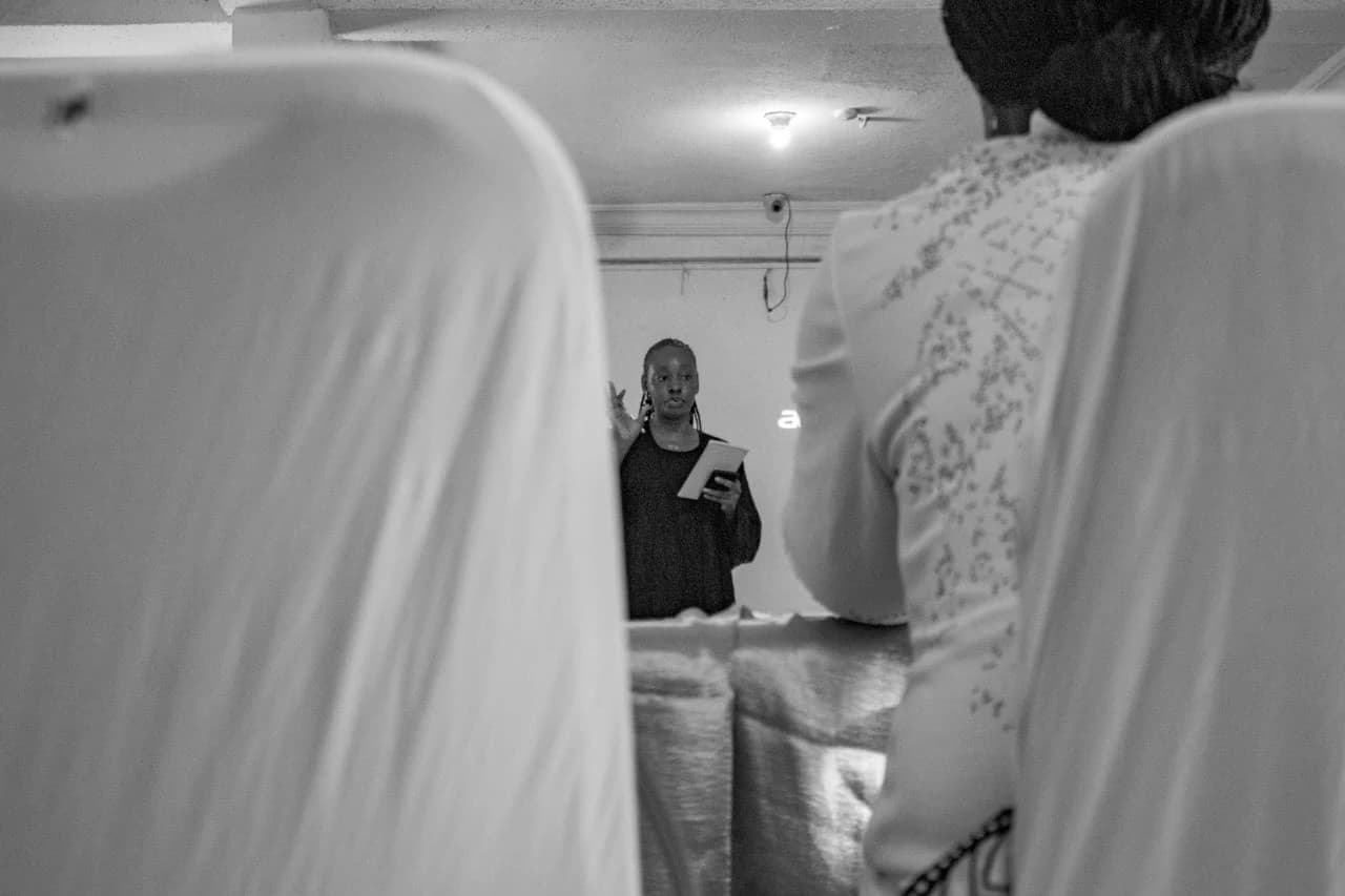 Peace speaking to a room, photographed in black and white