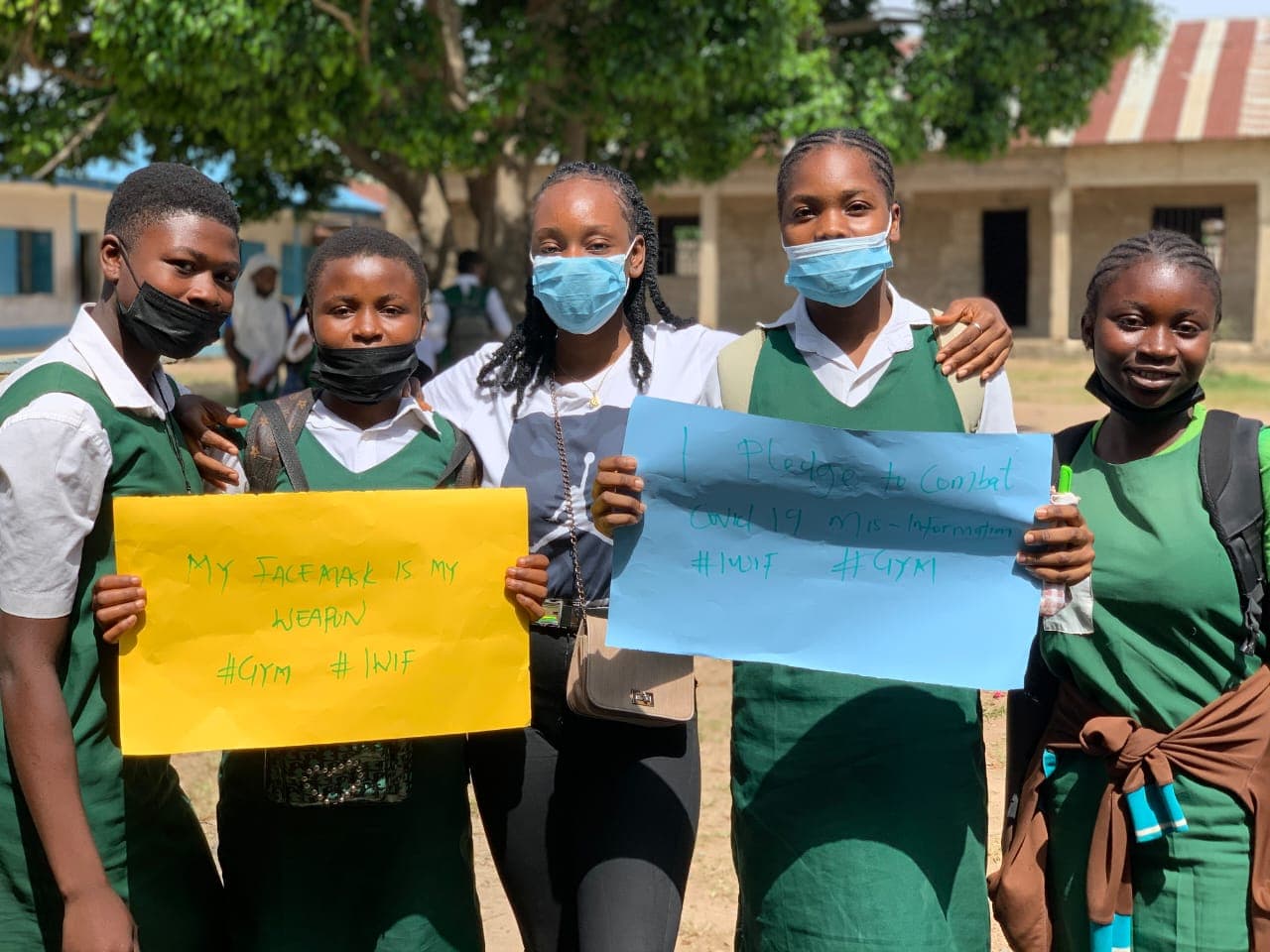 Students holding placards pledging to fight COVID-19 misinformation